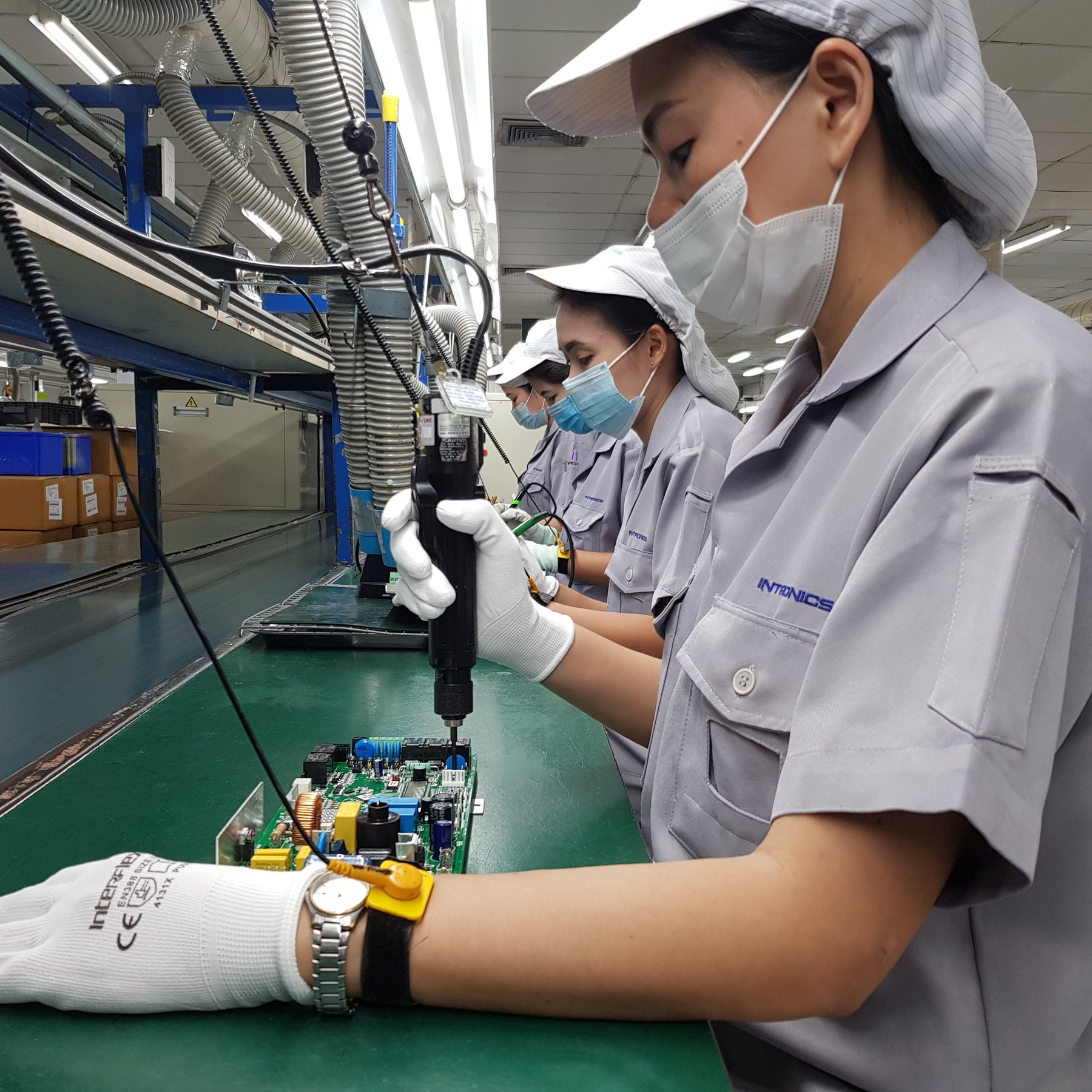 Technicians assembling circuit boards